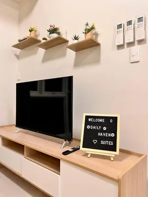 a tv on a cabinet with a sign on it at Staycation Casa Filipina in Manila