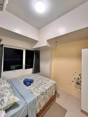 a bedroom with a bed and a window at Staycation Casa Filipina in Manila
