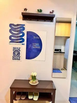 a table in a room with a sign on a wall at Staycation Casa Filipina in Manila