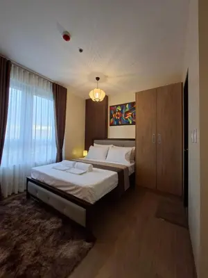 a hotel room with two beds and a window at THE Faithful Nest in General Trias