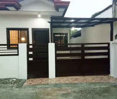a house with two doors and a fence at Kame House fully furnished 2BR in Bacoor