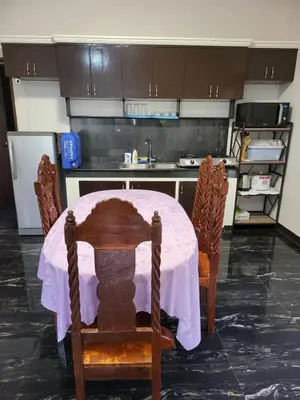 a kitchen with a table with a pink table cloth at Kame House fully furnished 2BR in Bacoor