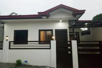 a small white house with a fence in front of it at Kame House fully furnished 2BR in Bacoor