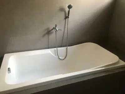 a white bath tub with a faucet in a bathroom at Kame House fully furnished 2BR in Bacoor
