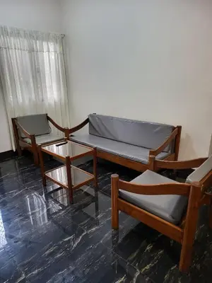 three chairs and a bed in a room at Kame House fully furnished 2BR in Bacoor