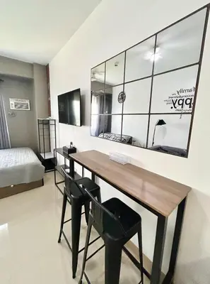 a room with a table and chairs and a bed at SELF CHECK-IN Near La Salle Dasma in Dasmariñas