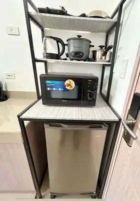 a microwave on a shelf in a kitchen at SELF CHECK-IN Near La Salle Dasma in Dasmariñas