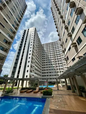 a large apartment building with a swimming pool at SELF CHECK-IN Near La Salle Dasma in Dasmariñas