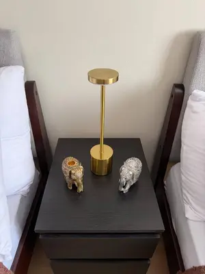 a table with two animal skulls on it next to two beds at The Luxe Forbeswood BGC in Manila