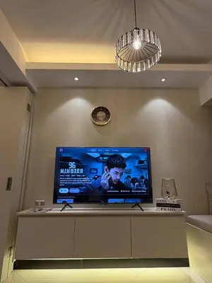 a large flat screen tv sitting on top of a table at The Luxe Forbeswood BGC in Manila