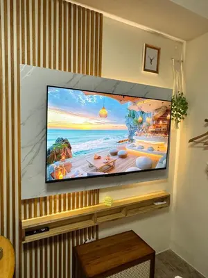 a flat screen tv hanging on a wall at A'more Cosy Stay Near Nuvali at Fullerton Suites in Silang