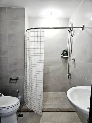 a bathroom with a shower and a toilet and a sink at MANILA AIR RESIDENCE 24 floor in Manila