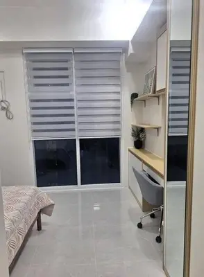 a bedroom with a window with blinds and a desk at MANILA AIR RESIDENCE 24 floor in Manila