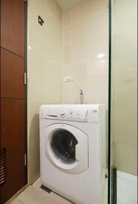 a washer and dryer in a small room at BGC Uptown Condotel in Manila