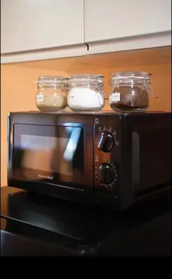 a toaster oven with two jars on top of it at BGC Uptown Condotel in Manila