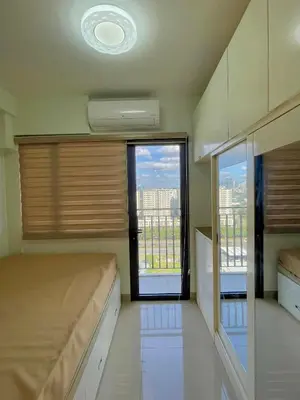a bedroom with a bed and a large window at Cozy condo unit in Manila
