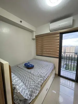 a bedroom with a bed with a blue bowl on it at Cozy condo unit in Manila