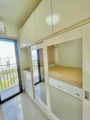 a small bedroom with a bed and a window at Cozy condo unit in Manila