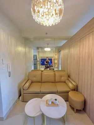 a living room with a couch and a table at Cozy condo unit in Manila