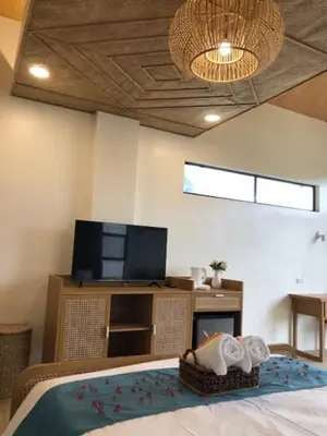 a bedroom with a bed and a flat screen tv at Island Garden Beach Resort in Manila