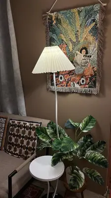 a table with a lamp and a plant in a room at Rosé Nights Luxury in Manila