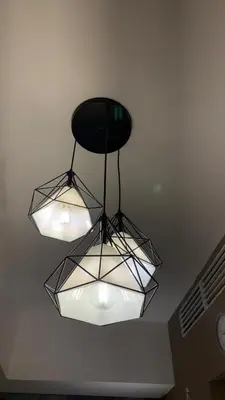 aendant light with three lights hanging from a ceiling at Rosé Nights Luxury in Manila