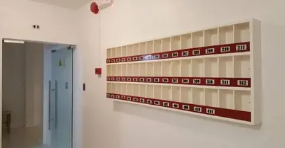 a shelf in a room with red and white tiles at ChaerinCL in Manila