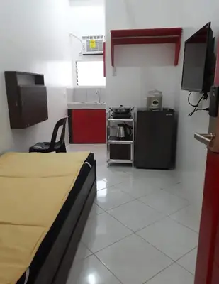 a room with a kitchen and a bed in it at ChaerinCL in Manila
