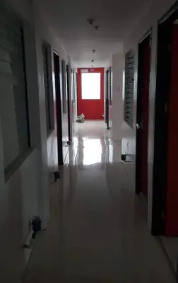 an empty hallway with a red door in a building at ChaerinCL in Manila