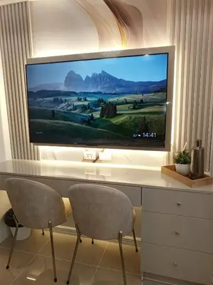 a flat screen tv sitting on top of a desk at Royal Suites at Shore Residences near SM MOA and Airport in Manila