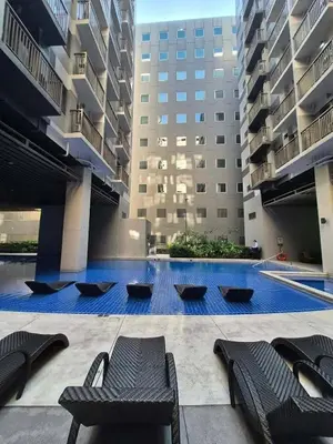 a swimming pool in the middle of a building at Calm Corner near Mall of Asia in Manila