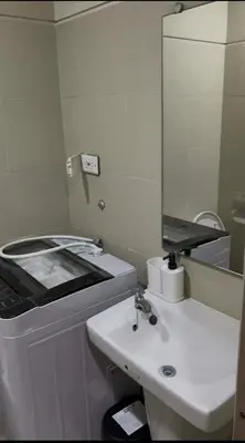 a bathroom with a sink and a mirror at Calm Corner near Mall of Asia in Manila