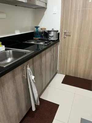a kitchen with a sink and a counter top at Calm Corner near Mall of Asia in Manila