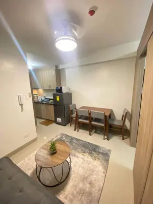 a living room with a couch and a table at Staycation Marcos Residence in Manila