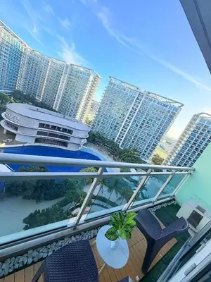a balcony with chairs and tables and buildings at Azure Destiny's Suites 1214 in Manila