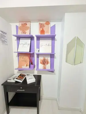 a table in a room with pictures on a wall at Azure Destiny's Suites 1214 in Manila