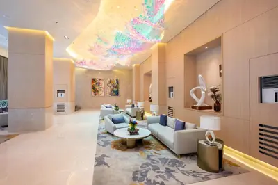 a large living room with couches and a chandelier at Uptown BGC Condo in Manila