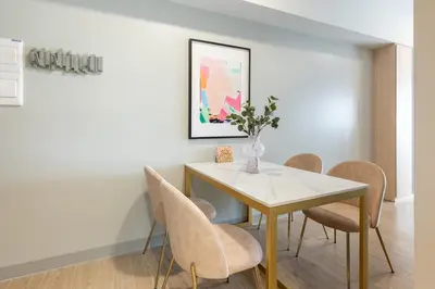 a dining room with a table and chairs at Uptown BGC Condo in Manila