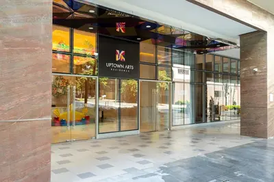 a building with a sign on the front of it at Uptown BGC Condo in Manila