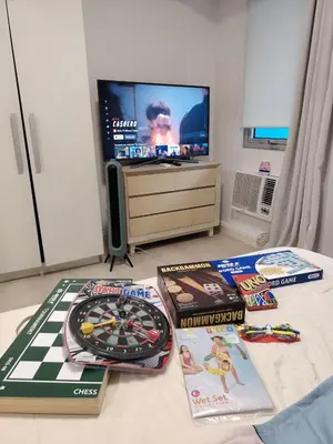a room with a table with games and a tv at Azure staycation near Airport beside SM Bicutan in Manila