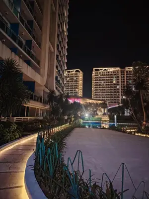a night view of a building with a large driveway at Azure staycation near Airport beside SM Bicutan in Manila