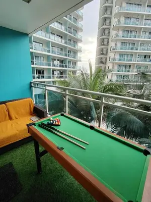 a pool table on the balcony of a condo at Azure staycation near Airport beside SM Bicutan in Manila