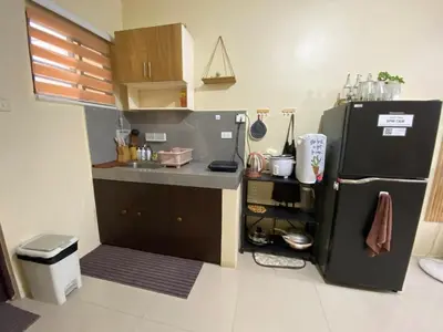 a small kitchen with a black refrigerator in a room at 1BR Cozy Townhouse - AC in room only in General Trias