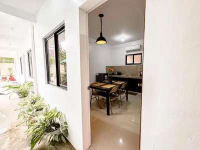 a kitchen and dining room with a table in a house at LAD Private Reosrt in Dasmariñas
