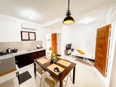 a kitchen and living room with a dining table and a kitchen at LAD Private Reosrt in Dasmariñas