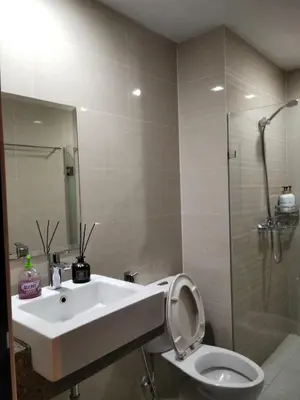 a bathroom with a sink and a toilet and a shower at Cluster4 4A in Manila