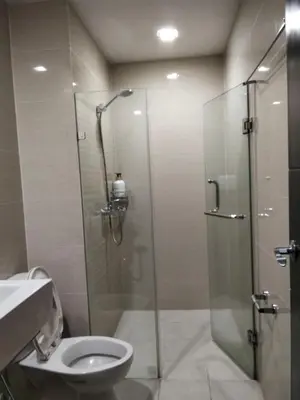 a bathroom with a shower with a toilet and a sink at Cluster4 4A in Manila