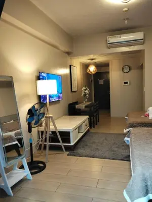 a living room with a bed and a table at Cluster4 4A in Manila