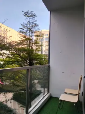 a white chair sitting on a balcony with a window at Cluster4 4A in Manila