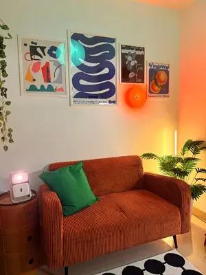 a living room with a couch and some pictures at Euphoria Suites Shore 2 Tower 1 Residences in Manila